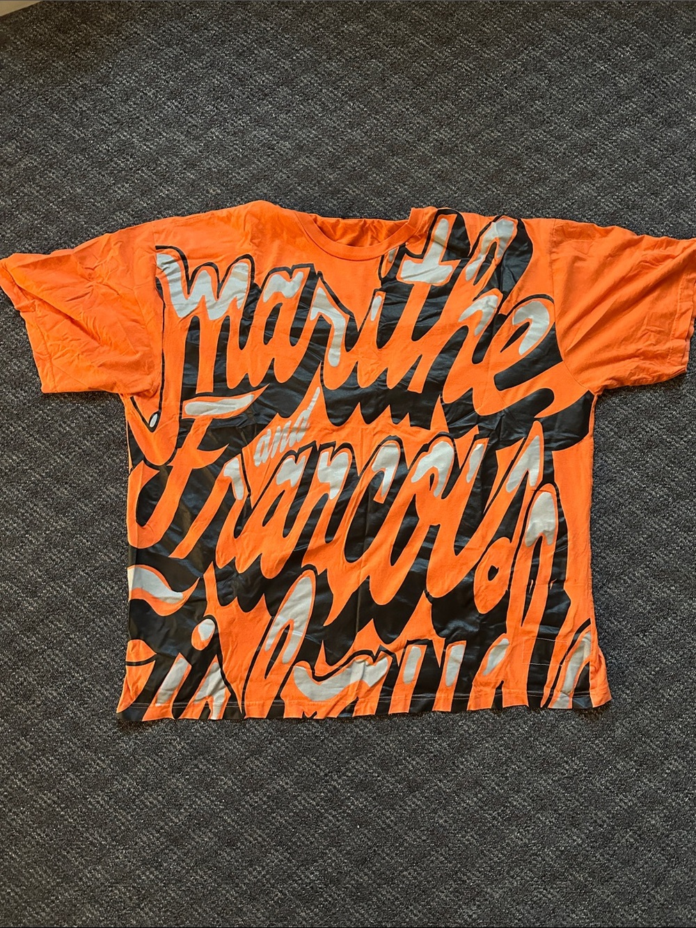 Marithe Francois Girbaud Bold Orange Graphic Tee with Black & Silver Script